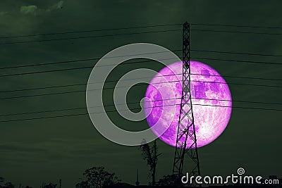 Full purple crow Moon and silhouette power electric pole and the night sky Stock Photo