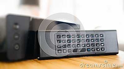 Full qwerty keyboard next to internet tv box Stock Photo