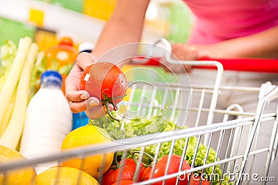 Full shopping cart at supermarket Stock Photo