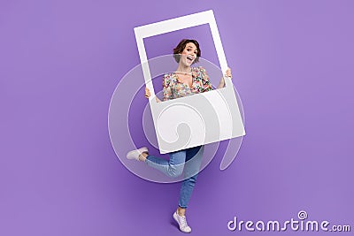 Full size photo of attractive young woman hold instant photo frame dressed stylish flower print clothes on Stock Photo