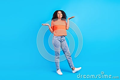 Full size photo of cheerful happy afro american woman shrug shoulders clueless isolated on blue color background Stock Photo