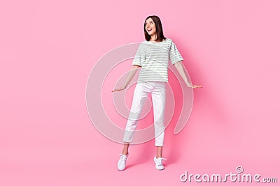 Full size photo of pretty positive girl striped t-shirt white pants shoes interested looking empty space isolated on Stock Photo