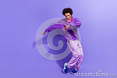 Full size photo of stylish positive person wear violet hoodie pants dancing modern hip hop music isolated on purple Stock Photo