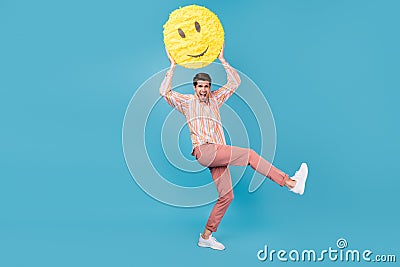 Full size photo of young excited guy happy positive hold big yellow smile emoji isolated over blue color background Stock Photo
