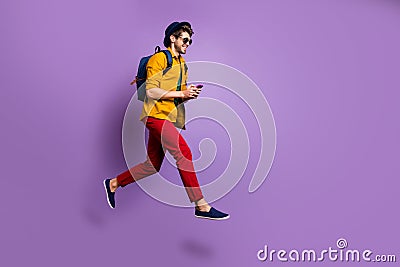 Full size profile side photo of positive guy jump use cellphone search online shopping blogs run after discounts wear Stock Photo