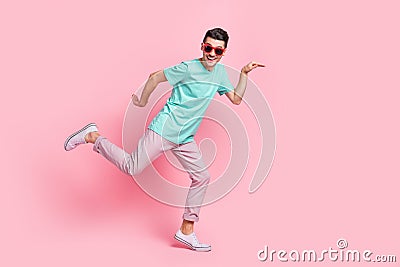 Full size profile side photo of young excited man happy smile have fun posing comic isolated over pastel color Stock Photo