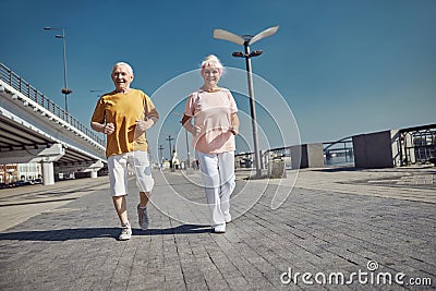 Sporty pensioners working out on the river bank Stock Photo