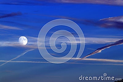 Full supermoon in dramatic blue sky and clouds Stock Photo