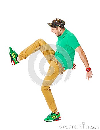 Fullbody portrait of young male kicking in studio isolated on white. Stock Photo