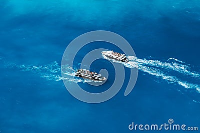 Fully occupied tourist boats in open sea on trip to the world most famous Navagio Beach on Zakynthos Island in Greece Stock Photo