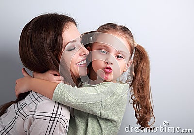 Fun bully kid girl showing kiss sign with mother lipstick kiss m Stock Photo