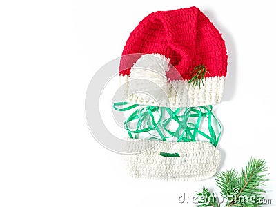 Fun Christmas composition. Knitted hat and beard, green ribbon are in the form of the face of Santa Claus on a white background. Stock Photo