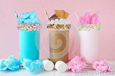 Cotton candy and smores summer milkshakes against a pastel pink background Stock Photo