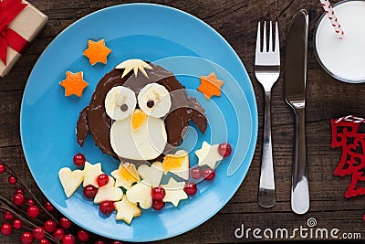 Cute penguin shaped chocolate spread sandwich with fresh fruit for kids Stock Photo