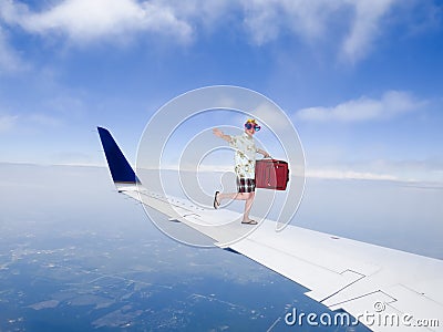 Fun and Funny Tourist Travel Flying on Airplane Jet Wing Stock Photo