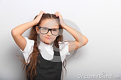 Fun happy pupil kid girl in eyeglasses scratching the head two h Stock Photo