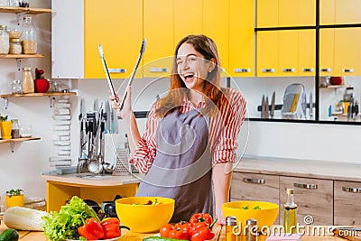 Fun home cooking joyful lady vegetable salad Stock Photo