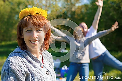 Fun picnic with friends. A wreath of dandelions on his head Stock Photo
