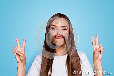 Fun prank joy entertainment concept. Close up portrait of young charming brunette shows v-sign and holds her hair over Stock Photo