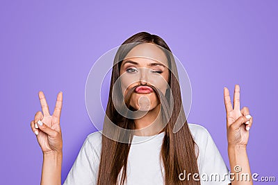 Fun prank joy entertainment concept. Close up portrait of young charming brunette shows v-sign and holds her hair over Stock Photo