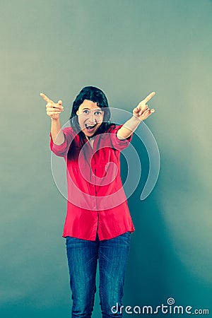 Fun 30s woman shouting with extrovert hand gesture Stock Photo