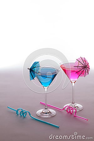 Fun vacation party drinks. Pink and blue cocktails glasses with Stock Photo