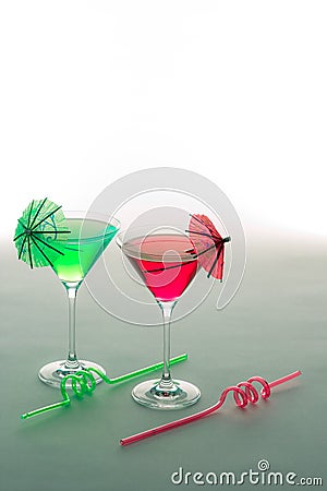 Fun vacation party drinks. Red and green cocktails glasses with Stock Photo