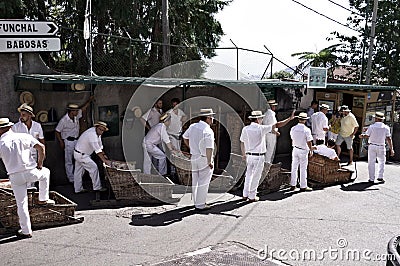 Funchal, Madeira, Portugal: Traditional descent with `Carros de cesto` in portoguese language means `straw chari Editorial Stock Photo