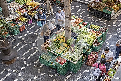 Vegetable sale at stall on decorated black and white flooring at covered market courtyard, Funchal, Madeira Editorial Stock Photo
