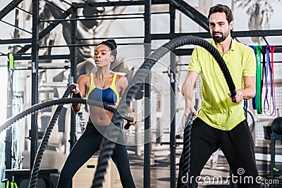 Functional training with battle rope in gym Stock Photo