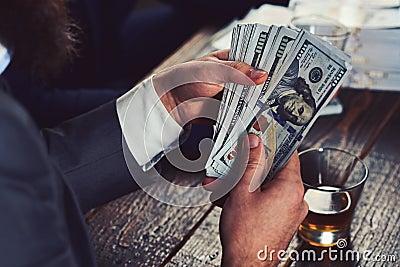 Funding project by raising monetary contributions. Hands counting us dollar banknotes. Cash money in hands of Stock Photo