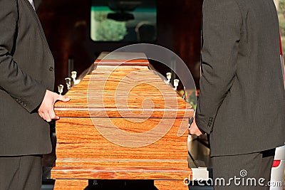 Funeral with casket carried by coffin bearer Stock Photo