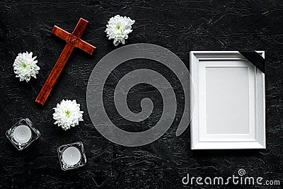 Funeral. Mockup of portrait of the deceased, of dead person. Frame with black ribbon near flowers, candles and cross on Stock Photo