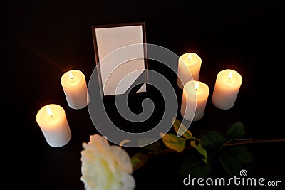 Photo frame with black ribbon, flower and candles Stock Photo