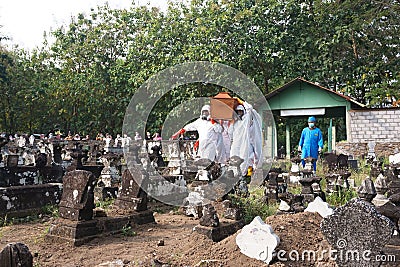 Funeral procession for covid19 victim by team wearing hazmat suits as protection Editorial Stock Photo