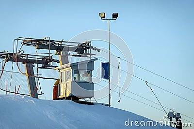 Funicular control cabin on top of the mountain in skiing resort. Cables pulling skiers and snowboarders up the mountain Stock Photo