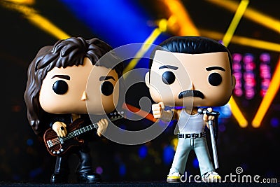 Funko POPO vinyl figures of Freddie Mercury and John Deacon(Queen) on concert stage background Editorial Stock Photo