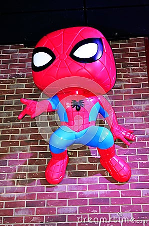 Funko Spiderman hangs from brick wall Editorial Stock Photo