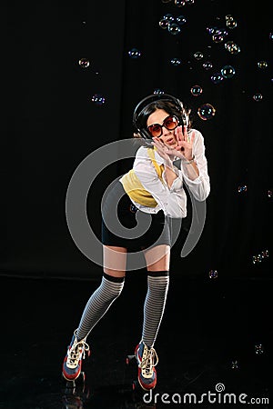 Funky girl on rollerskates and headphones Stock Photo