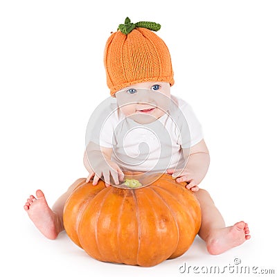 Funny adorable little baby playing with big pumpkin Stock Photo