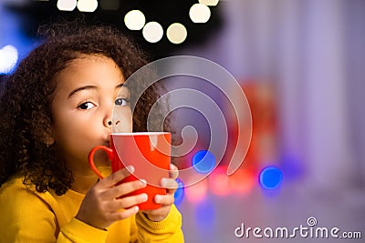 Funny african girl with cup of warm winter cocoa Stock Photo