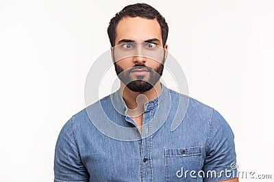 Funny amused man with beard in blue shirt crossing his eyes looking crazy and stupid, fooling around, having fun, vision problems Stock Photo