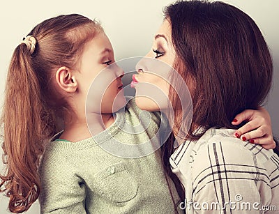 Funny amusing young mother wanting to kiss her comical grimacing Stock Photo