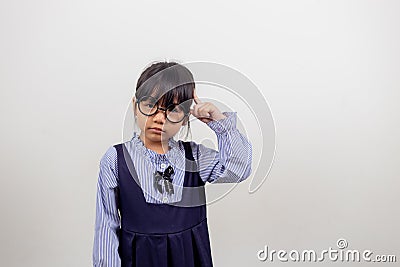 funny Asian child girl wearing glasses on a white background Stock Photo