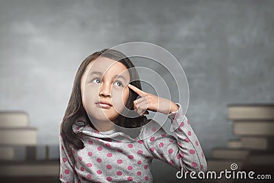 Funny asian kid thinking for new inspiration Stock Photo