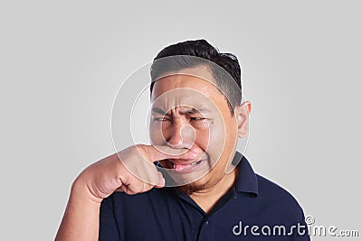 Asian Man Close His Nose Sick of Bad Smell Stock Photo