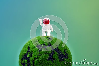 Funny astronaut on a green planet Stock Photo