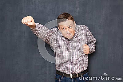 Funny awkward office worker is posing like flying superman Stock Photo