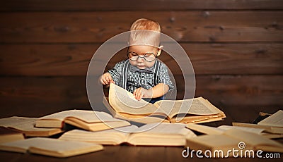 Funny baby with books in glasses Stock Photo