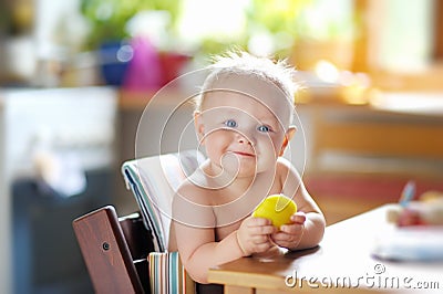 Funny baby eating healthy food Stock Photo